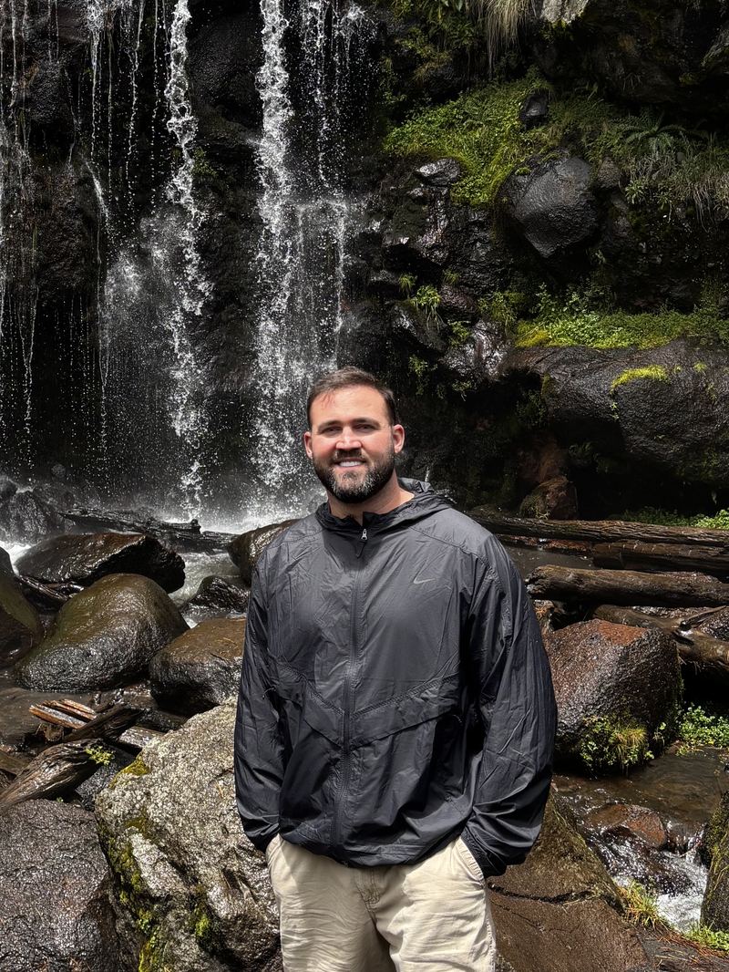 Bradley Morgan, founder of Sego Ridge, outdoors in front of a waterfall